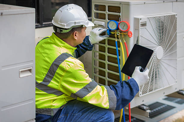 Professional Heat Pump Repair technician working in Wallis, TX